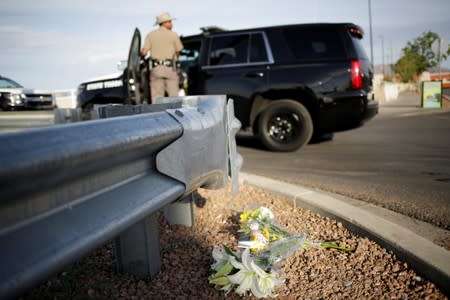 Flowers are seen at the site of a mass shooting where 20 people lost their lives at a Walmart in El Paso