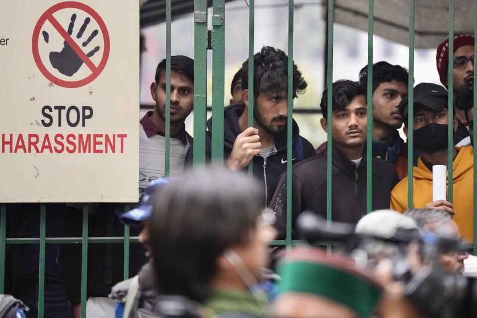 Tensions escalated in the university after a student group said it planned to screen a banned documentary that examines Indian Prime Minister Narendra Modi's role during 2002 anti-Muslim riots, prompting dozens of police equipped with tear gas and riot gear to gather outside campus gates. (Manish Swarup / AP)