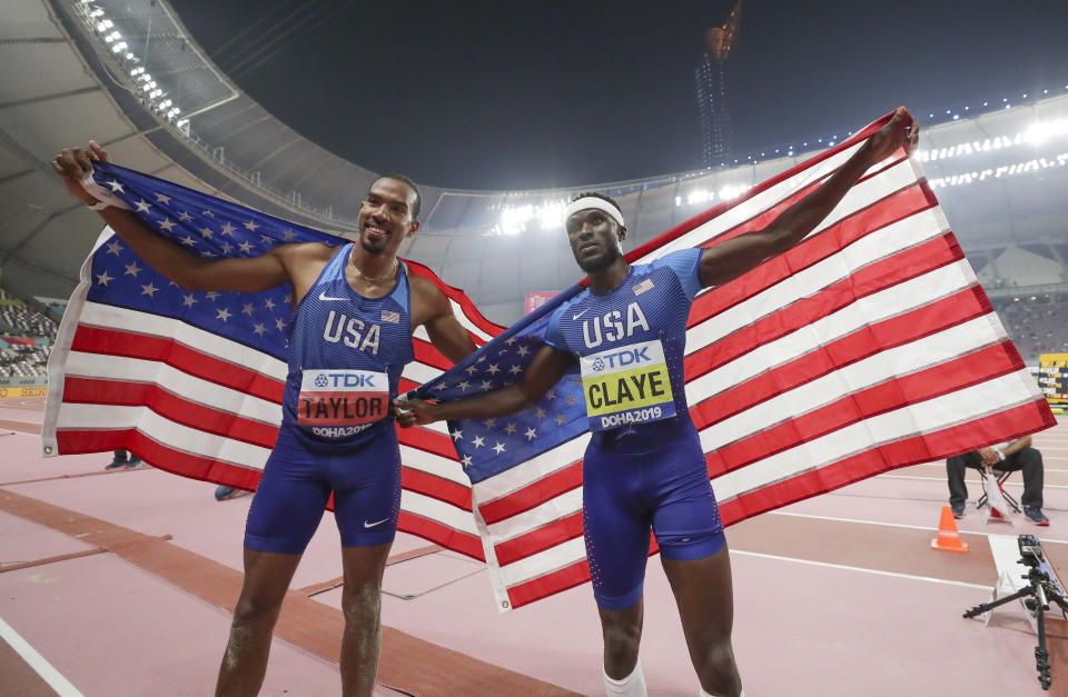 Christian Taylor, left, of the United States, and Will Claye, of the United States, pose together after the men's triple jump final at the World Athletics Championships in Doha, Qatar, Sunday, Sept. 29, 2019. Taylor won the gold medal and Claye won the silver. (AP Photo/Hassan Ammar)