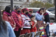 Family members of missing and murdered indigenous women in Montana gather in front of the state Capitol in Helena, Mont., Wednesday, May 5, 2021. They received colorful shawls in a traditional Native American ceremony called "wiping away of tears." From Washington to Indigenous communities across the American Southwest, top government officials, family members and advocates gathered Wednesday as part of a call to action to address the ongoing problem of violence against Indigenous women and children. (AP Photo/Iris Samuels)