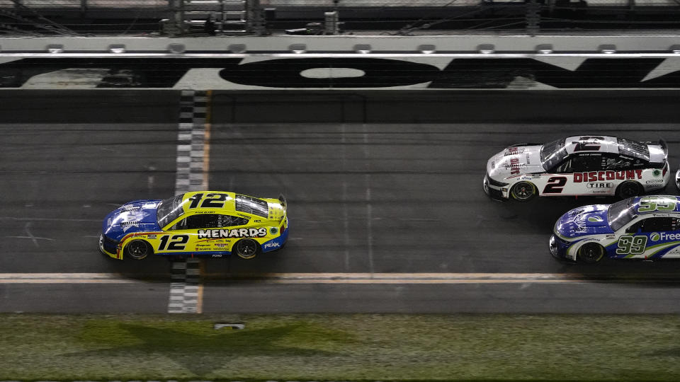 Ryan Blaney (12) beats Austin Cindric (2), and Daniel Suarez (99) to the line to win the second stage during the NASCAR Daytona 500 auto race Monday, Feb. 19, 2024, at Daytona International Speedway in Daytona Beach, Fla. (AP Photo/Chris O'Meara)