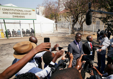 Nkululeko Sibanda, spokeperson for Nelson Chamisa, the leader of opposition Movement for Democratic Change (MDC) party, talks to the media outside the Constitutional Court in Harare, Zimbabwe, August 24, 2018. REUTERS/Philimon Bulawayo