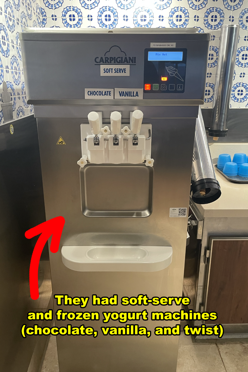 Commercial soft serve machine with three dispensers and a menu listing chocolate, vanilla, and twist flavors