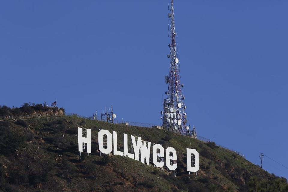 The Hollywood sign is seen vandalized Sunday, Jan. 1, 2017. Los Angeles residents awoke New Year's Day to find a prankster had altered the famed Hollywood sign to read "HOLLYWeeD." Police have notified the city's Department of General Services, whose officers patrol Griffith Park and the area of the rugged Hollywood Hills near the sign. California voters in November approved Proposition 64, which legalized the recreational use of marijuana, beginning in 2018. (AP Photo/Damian Dovarganes)