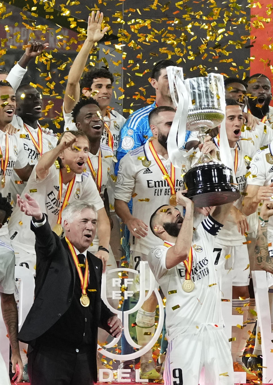 Real Madrid's Karim Benzema lifts the trophy next to head coach Carlo Ancelotti after Madrid defeated Osasuna 2-1 in the Copa del Rey soccer final at La Cartuja stadium in Seville, Spain, Saturday, May 6, 2023. (AP Photo/Jose Breton)