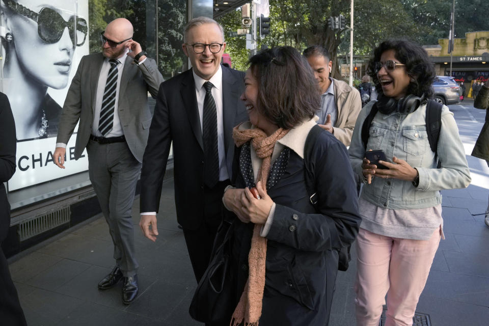 Australian Prime Minister Anthony Albanese, second left, interacts with members of the public as he walks in central Sydney after a press briefing, Wednesday, Sept. 14, 2022. Albanese announced a square in honor of the late queen and that he will be taking to London the leaders of Papua New Guinea, the Solomon Islands and Tuvalu with him along with 10 ordinary people from each country to attend the funeral of Queen Elizabeth II. (AP Photo/Rick Rycroft)