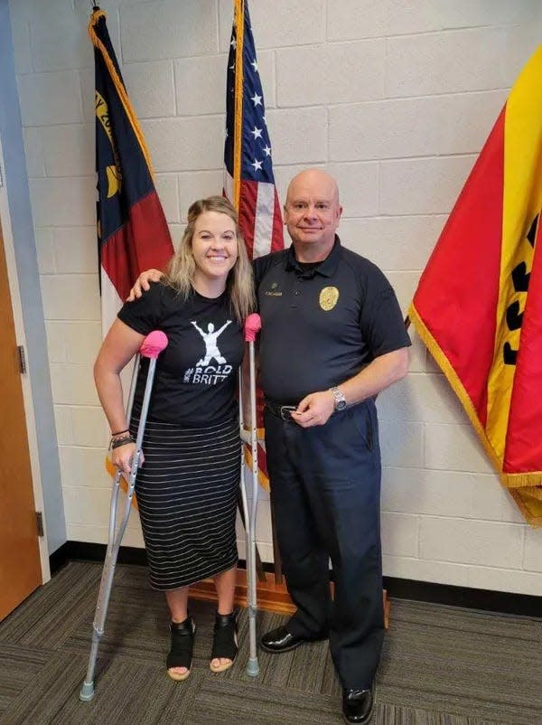 Brittany Cass, the survivor of a head-on drunk driving accident, stands with New Bern Police Chief Patrick Gallagher. Cass's nonprofit, Bold Like Britt, will hold a fundraiser this weekend to raise money for a billboard near the site of her wreck.