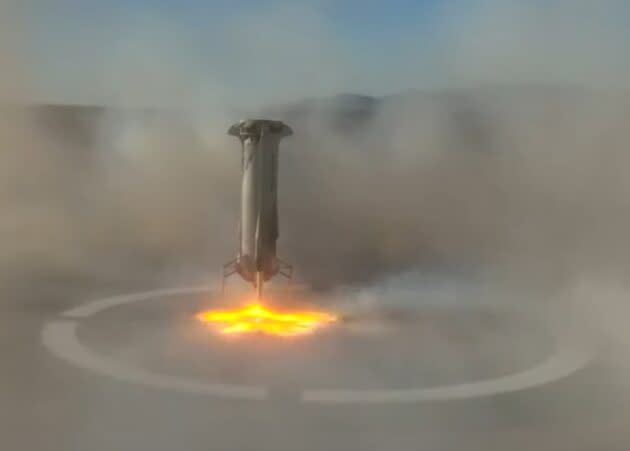 The New Shepard booster touches down on its landing pad. (Blue Origin via YouTube)