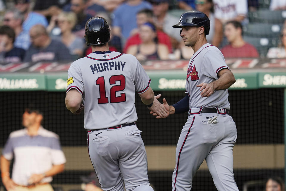 Atlanta Braves' Sean Murphy (12) is greeted by Matt Olson after scoring against the Cleveland Guardians during the first inning of a baseball game Wednesday, July 5, 2023, in Cleveland. (AP Photo/Sue Ogrocki)