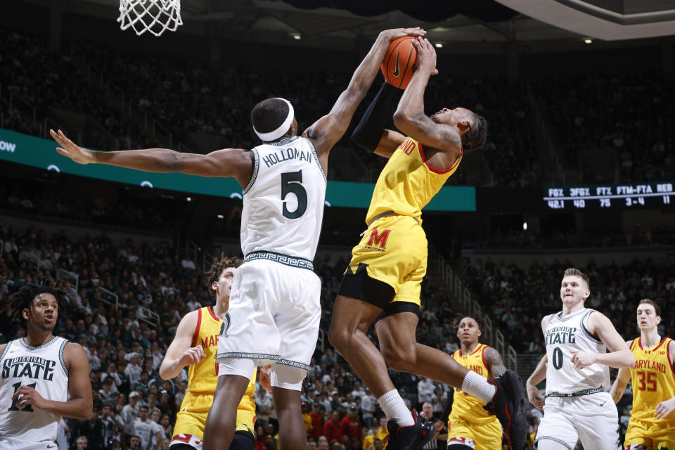 Michigan State guard Tre Holloman (5) blocks a shot by Maryland guard Jahmir Young, center right, during the first half of an NCAA college basketball game, Saturday, Feb. 3, 2024, in East Lansing, Mich. (AP Photo/Al Goldis)