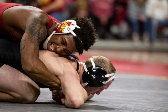 Iowa&#39;s Kaleb Young wrestles Iowa State&#39;s David Carr at 157, during the CyHawk dual, on Sunday, Dec. 5, 2021, at Hilton Coliseum, in Ames. 