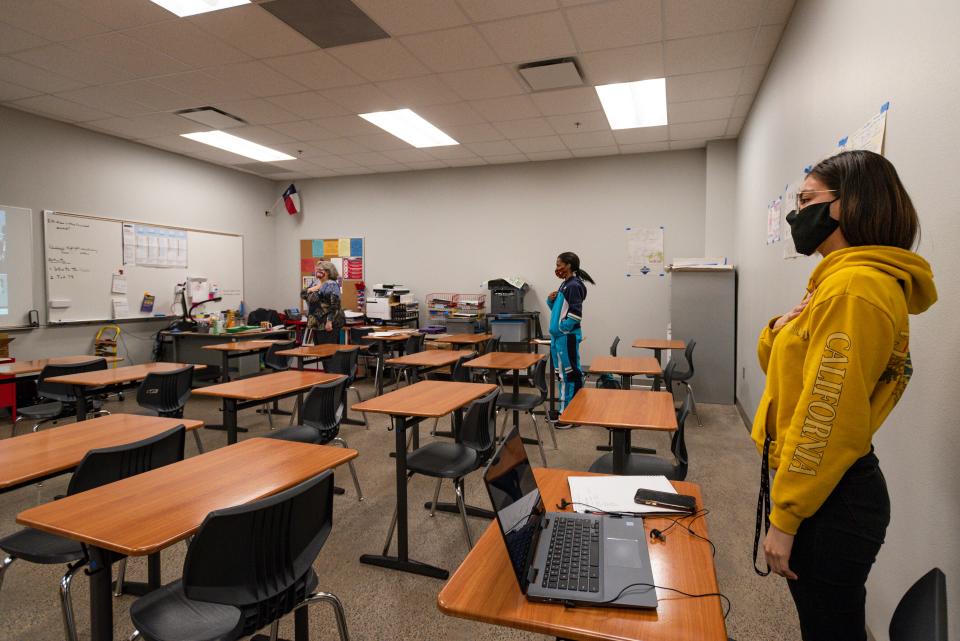 In Odessa, Texas, where students have the option of in-person classes, Odessa High School government teacher Nita Merrifield, left, and her students Kheeauna Liee, 17, center, and Joseline Fabela, 18, right, stand for the Pledge of Allegiance as they watch the inauguration of President Joe Biden and Vice President Kamala Harris on Jan. 20.