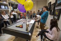 Classmates surround a table with photos of Walker Vincent during a 16th birthday party for Walker at Leslie Jacob's home on Sunday, December 29, 2019 in Lafayette, La. Walker Vincent was one of the victims in the plane crash on Saturday. Family and friends threw him a birthday party where they released LSU balloons and marked gifts with their favorite memories of Walker for his father. (Brad Kemp/The Advocate via AP)