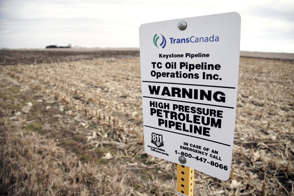 FILE - In this Jan. 9, 2020, file photom a sign identifies the existence of a buried oil pipeline under a corn field in rural Milford, Neb. A U.S. energy boom over the last decade drove a huge expansion of the nation's pipeline network, but the pandemic, political opposition and legal setbacks threaten to slow that growth. (AP Photo/Nati Harnik, File)