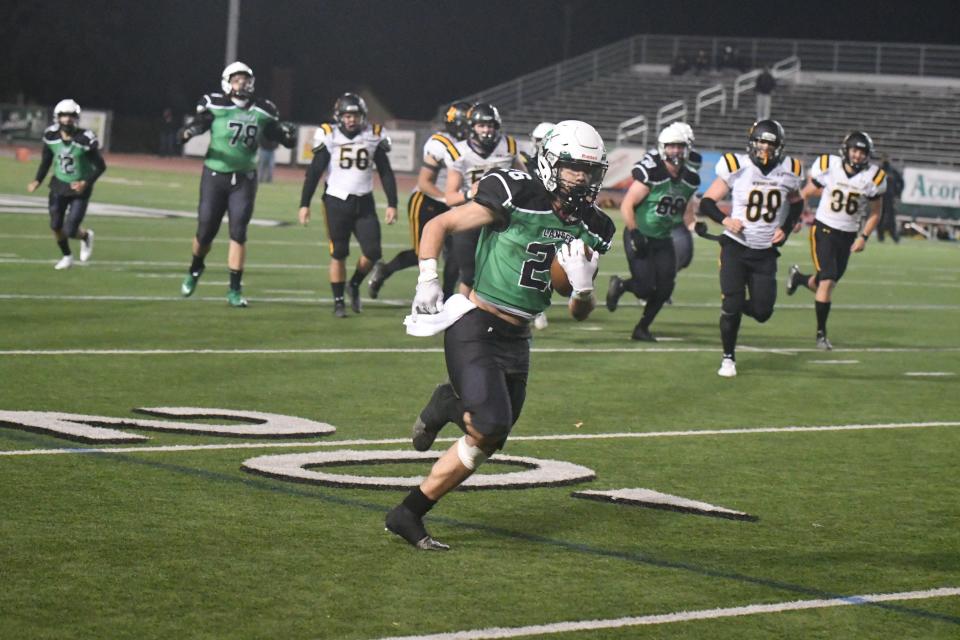 Thousand Oaks High's Matthew Garcia breaks free of the Newbury Park defense during the Lancers' win on March 21 that snapped the program's 25-game losing streak.