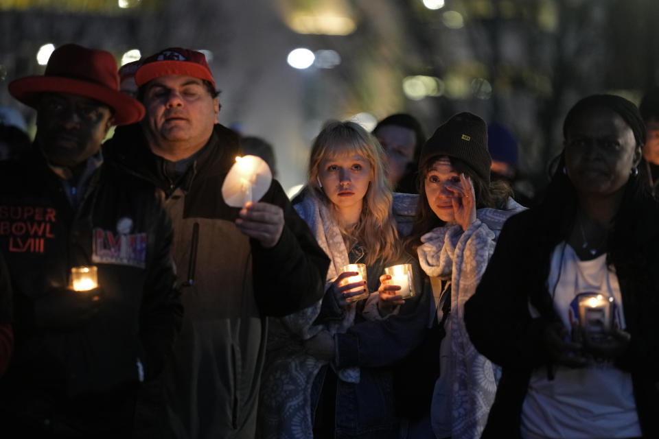 People attend a candlelight vigil for victims of a shooting at a Kansas City Chiefs Super Bowl victory rally Thursday, Feb. 15, 2024 in Kansas City, Mo. More than 20 people were injured and one woman killed in the shooting near the end of Wednesday's rally held at nearby Union Station. (AP Photo/Charlie Riedel)