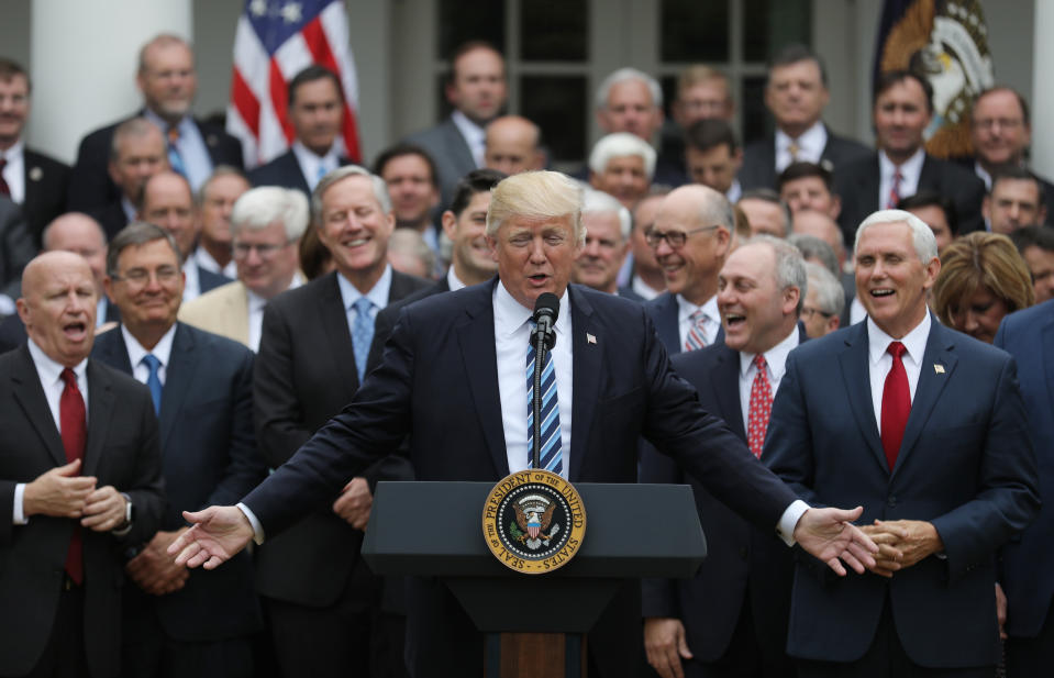 U.S. President Donald Trump (C) gathers with Vice President Mike Pence (R) and Congressional Republicans in the Rose Garden of the White House after the House of Representatives approved the American Healthcare Act, to repeal major parts of Obamacare and replace it with the Republican healthcare plan, in Washington, U.S., May 4, 2017. REUTERS/Carlos Barria