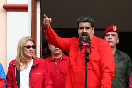 Venezuela's President Nicolas Maduro attends a rally in support of his government and to commemorate the 61st anniversary of the end of the dictatorship of Marcos Perez Jimenez next to his wife Cilia Flores in Caracas, Venezuela January 23, 2019. Miraflores Palace/Handout via REUTERS
