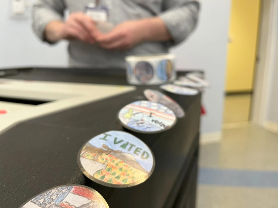 "I voted" stickers line a vote counting machine in Keene.