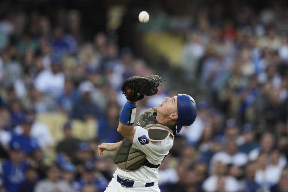 Los Angeles Dodgers catcher Will Smith catches a foul ball hit by Cincinnati Reds' Jeimer Candelario during the fifth inning of a baseball game in Los Angeles, Saturday, May 18, 2024. (AP Photo/Ashley Landis)