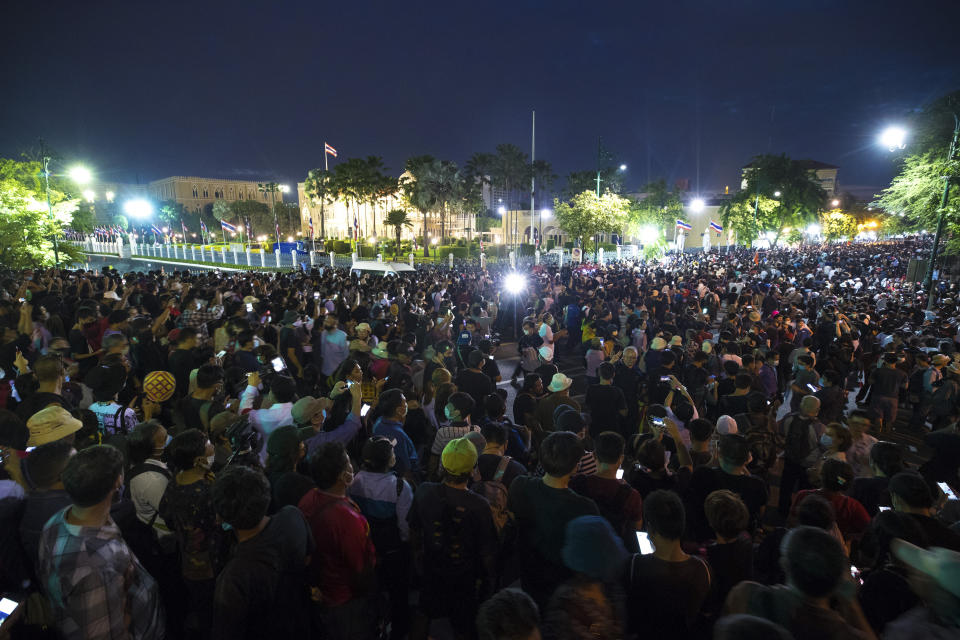 Thousand of pro-democracy protesters gather outside the Government House during a rally in Bangkok, Thailand, Wednesday, Oct. 14, 2020. Thousands of anti-government protesters gathered Wednesday for a rally being held on the anniversary of a 1973 popular uprising that led to the ousting of a military dictatorship, amid a heavy police presence and fear of clashes with political opponents. (AP Photo/Sakchai Lalit)