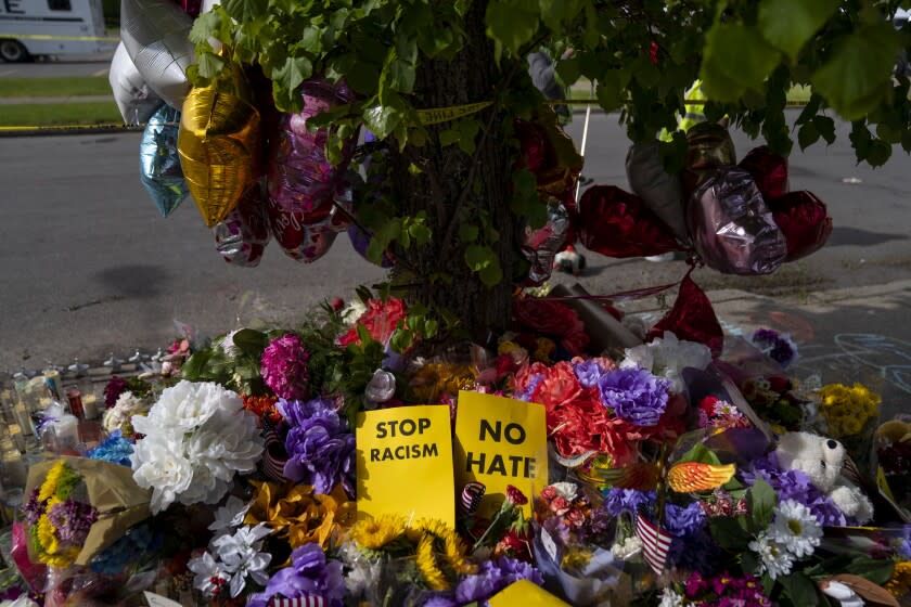 BUFFALO, NY - MAY 18: A memorial across the street from Tops Friendly Market at Jefferson Avenue and Riley Street on Wednesday, May 18, 2022 in Buffalo, NY. The Supermarket was the site of a fatal shooting of 10 people at a grocery store in a historically Black neighborhood of Buffalo by a young white gunman is being investigated as a hate crime and an act of "racially motivated violent extremism," according to federal officials. (Kent Nishimura / Los Angeles Times)