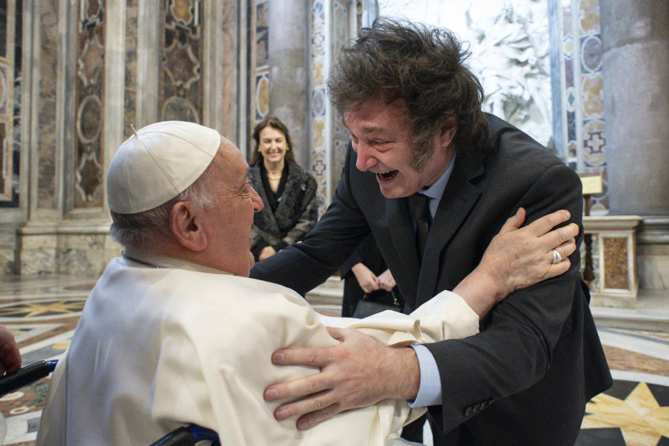 In this image made available by Vatican Media, Argentine President Javier Milei, right, greets Pope Francis prior to the start of the canonization mass of Argentine first female saint, María Antonia de Paz y Figueroa also known as "Mama Antula" presided over by Pope Francis in St. Peter's Basilica at The Vatican, Sunday, Feb. 11, 2024. At center Argentine Foreign Minister Diana Mondino looks on. (Vatican Media via AP, HO)