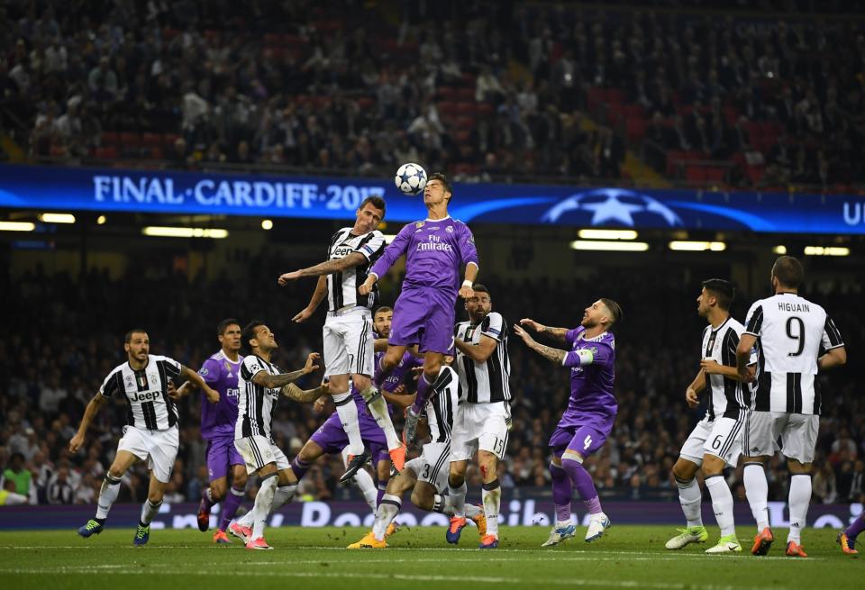 <p>Mario Mandzukic of Juventus and Cristiano Ronaldo of Real Madrid battle to win a header during the UEFA Champions League Final between Juventus and Real Madrid at National Stadium of Wales </p>