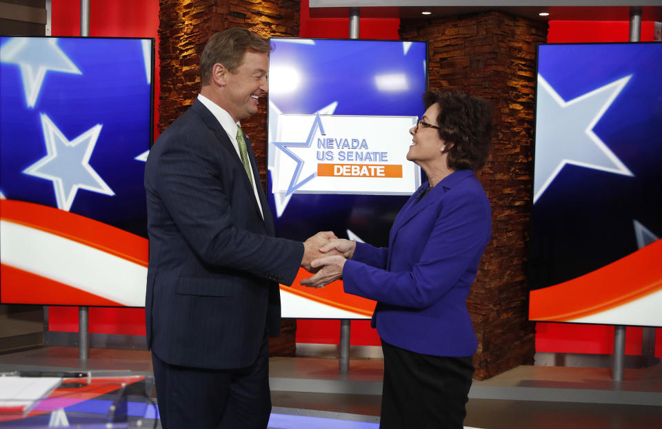 Sen. Dean Heller, R-Nev., left, and Rep. Jacky Rosen, D-Nev., shake hands before a U.S. Senate debate, Friday, Oct. 19, 2018, in Las Vegas. (AP Photo/John Locher, Pool)