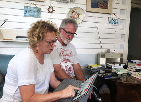 Eileen O’Brien, 65, and Michael O’Brien, 62, read the redacted report by U.S. Special Counsel Robert Mueller on Russian interference in the 2016 U.S. presidential election, at their home in Clearwater, Florida, U.S., April 18, 2019. REUTERS/Letitia Stein