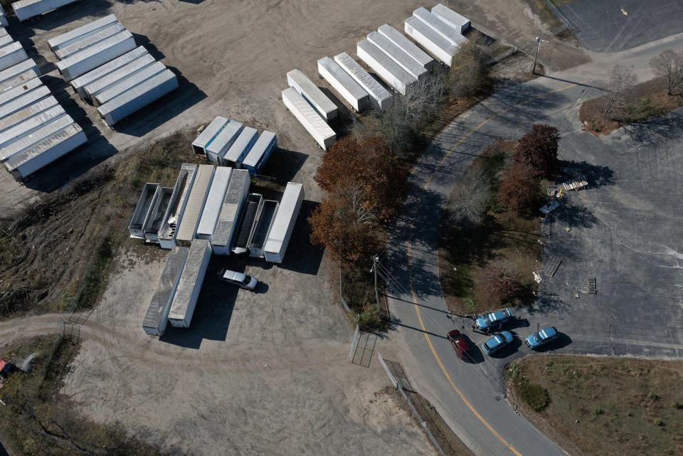 Image: In an aerial view, law enforcement officials are seen investigating the area where the suspect was found dead (Joe Raedle / Getty Images)