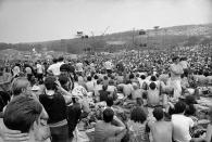 FILE - A portion of the hundreds of thousands of concert-goers who attended the Woodstock Music and Arts Festival held on a 600-acre pasture near Bethel, N.Y., Aug. 14, 1969. An estimated 450,000 people attended the Woodstock festival in August 1969, and most of that crowd was composed of teenagers or young adults now in the twilight of their lives. That ticking clock is why the Museum at Bethel Woods, based at the site of the festival, is immersed in a five-year project traveling around the United States recording the oral histories of people were there, preserving the Woodstock memories before they fade away. (AP Photo, File)