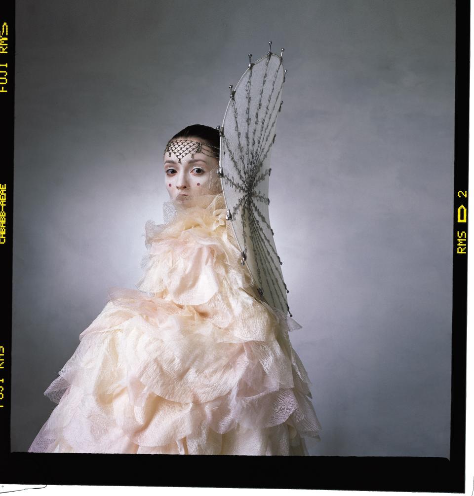 QUEEN OF NABOO: Amidala rules a small planet—home to beautiful cities and dark, teeming swamps. The chiffon and organza petals of her Final Parade Costume were individually dyed and then hand-painted. The freestanding collar was inspired by a Japanese parasol. Costume by Trisha Biggar.