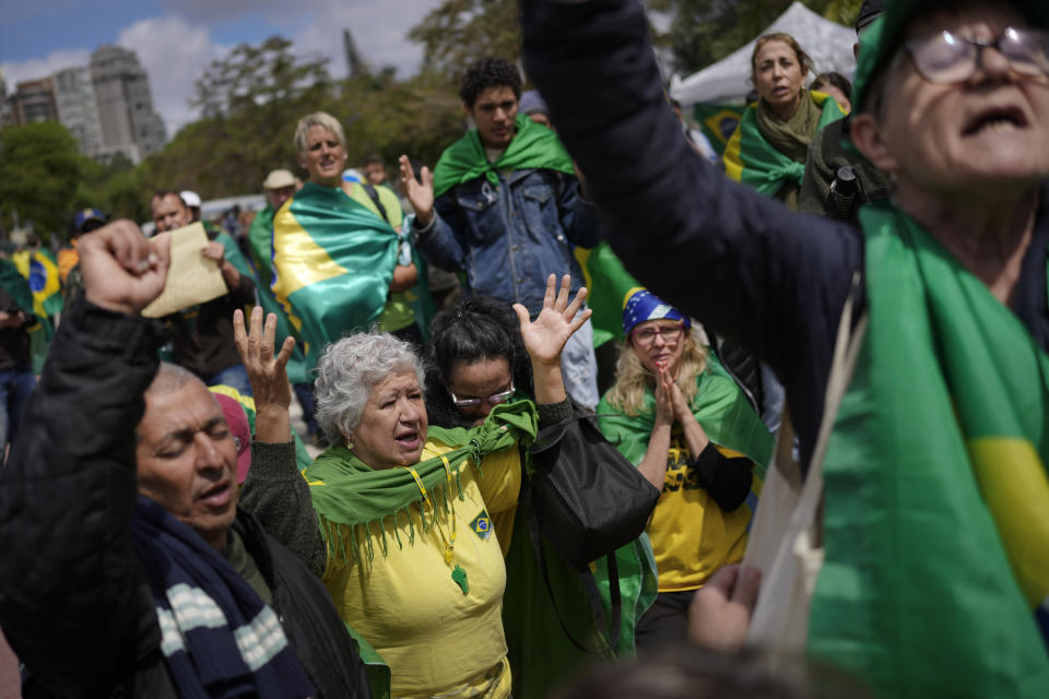 Supporters of outgoing President Jair Bolsonaro protest against his defeat in the country's presidential runoff, outside a military base in Sao Paulo, Brazil, Thursday, Nov. 3, 2022. Some supporters are calling on the military to keep Bolsonaro in power, even as his administration signaled a willingness to hand over the reins to his rival, President-elect Luiz Inacio Lula da Silva. (AP Photo/Matias Delacroix)