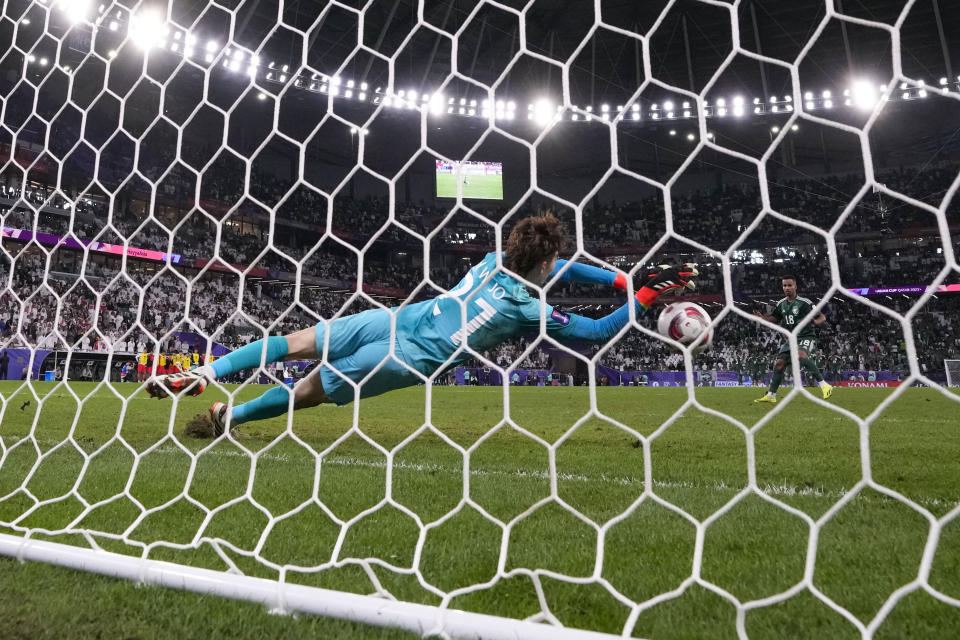 South Korea's goalkeeper Jo Hyeon-Woo makes a save in front of Saudi Arabia's Abdulrahman Ghareeb during a penalty shootout at the end of the Asian Cup Round of 16 soccer match between Saudi Arabia and South Korea, at the Education City Stadium in Al Rayyan, Qatar, Tuesday, Jan. 30, 2024. (AP Photo/Thanassis Stavrakis)