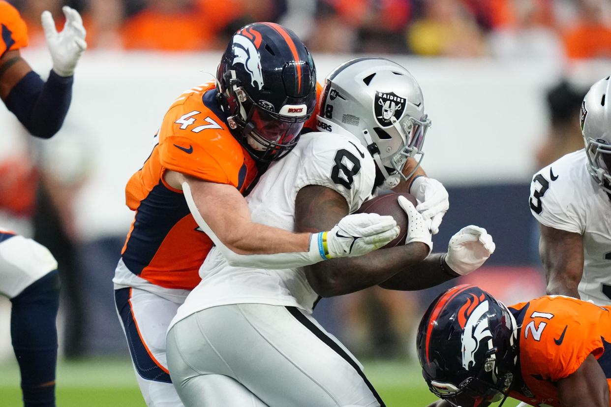 Denver Broncos linebacker Josey Jewell (47) tackles Las Vegas Raiders running back Josh Jacobs.