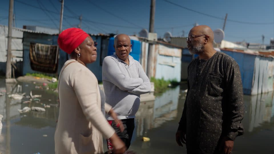 Mpahlwa (right) speaks with residents about the conditions at the Kosovo Informal Settlement in Philippi Township, Western Cape. - CNN