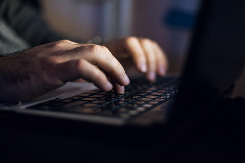 A man typing on the computer