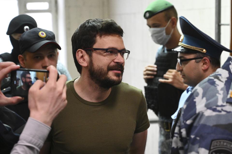 FILE Russian opposition activist and a municipal deputy of the Krasnoselsky district Ilya Yashin is escorted inside the Basmanny district court prior to a hearing on his detention in Moscow, Russia, Wednesday, July 13, 2022. Prominent Russian opposition politician Ilya Yashin may be in jail, but he refuses to be silenced. His social media accounts are regularly updated with anecdotes about his life in detention or video commentary criticizing President Vladimir Putin's rule. (AP Photo/Dmitry Serebryakov, File)