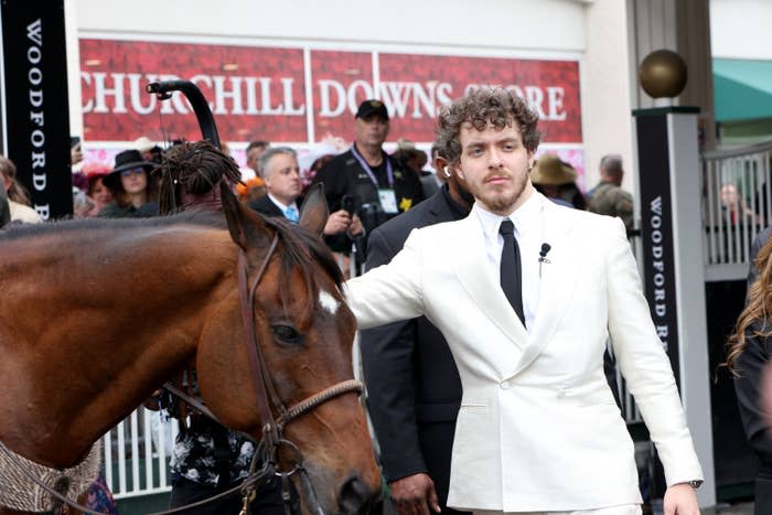 Jack stands with a horse