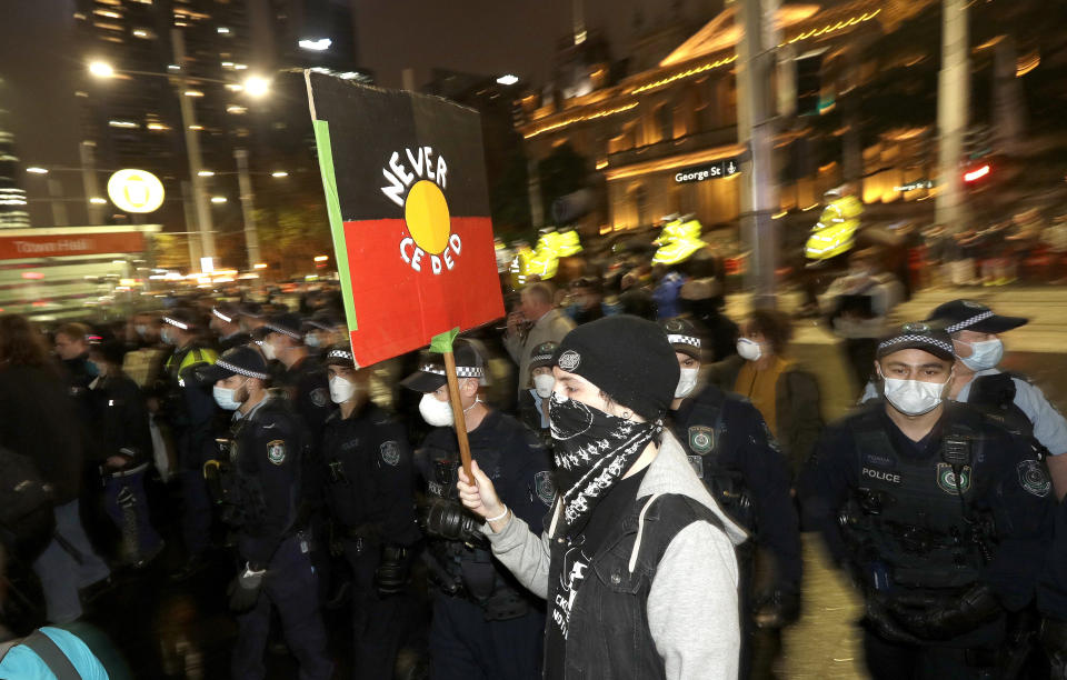 Police move in to disperse protesters that had gathered in Sydney, Friday, June 12, 2020, to support U.S. protests over the death of George Floyd. Hundreds of police disrupted plans for a Black Lives Matter rally but protest organizers have vowed that other rallies will continue around Australia over the weekend despite warnings of the pandemic risk. (AP Photo/Rick Rycroft)