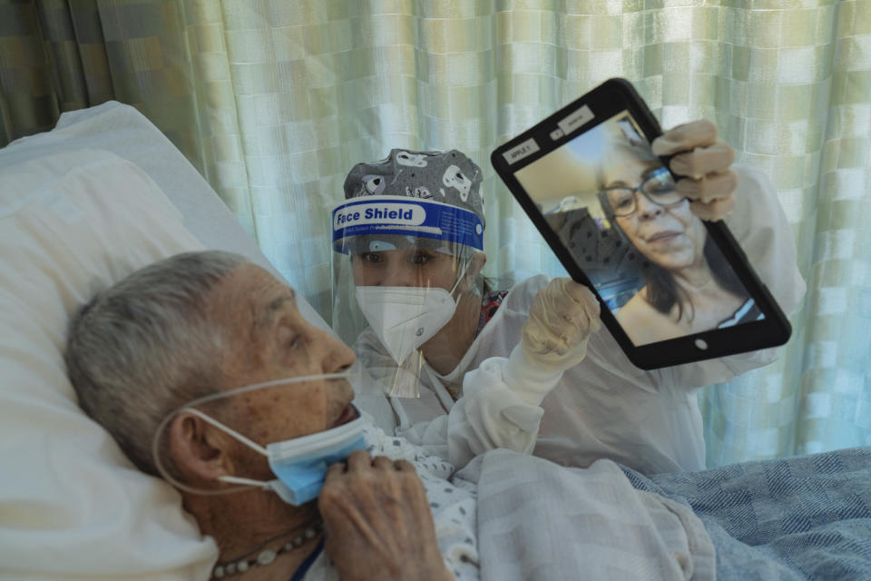 Maika Álvarez ayuda a José Montoya a hablar con su hija a través de FaceTime en el Centro de Rehabilitación Transitoria Canyon en Albuquerque, Nuevo México, agosto de 2020. (Isadora Kosofsky/The New York Times)