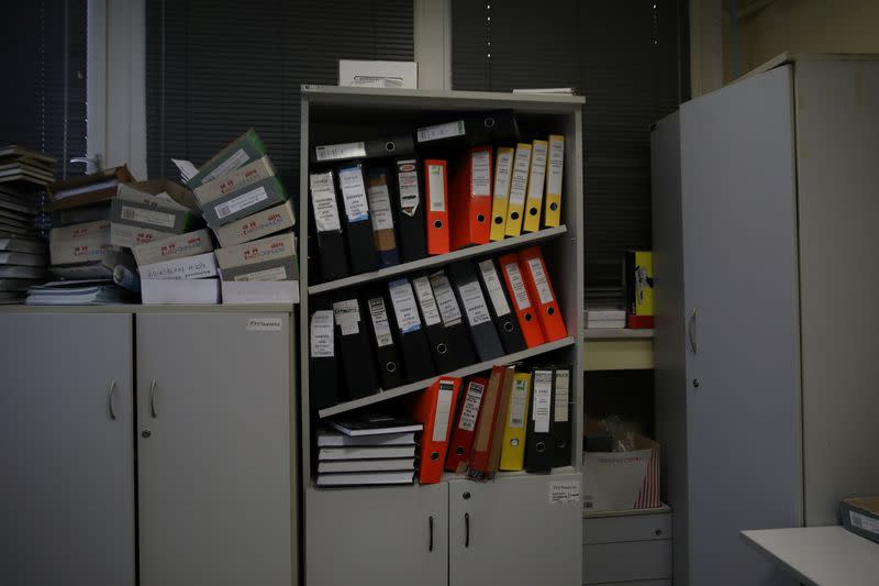 Folders are seen on a bookcase at a Greek Manpower Employment Organisation (OAED) office near Athens