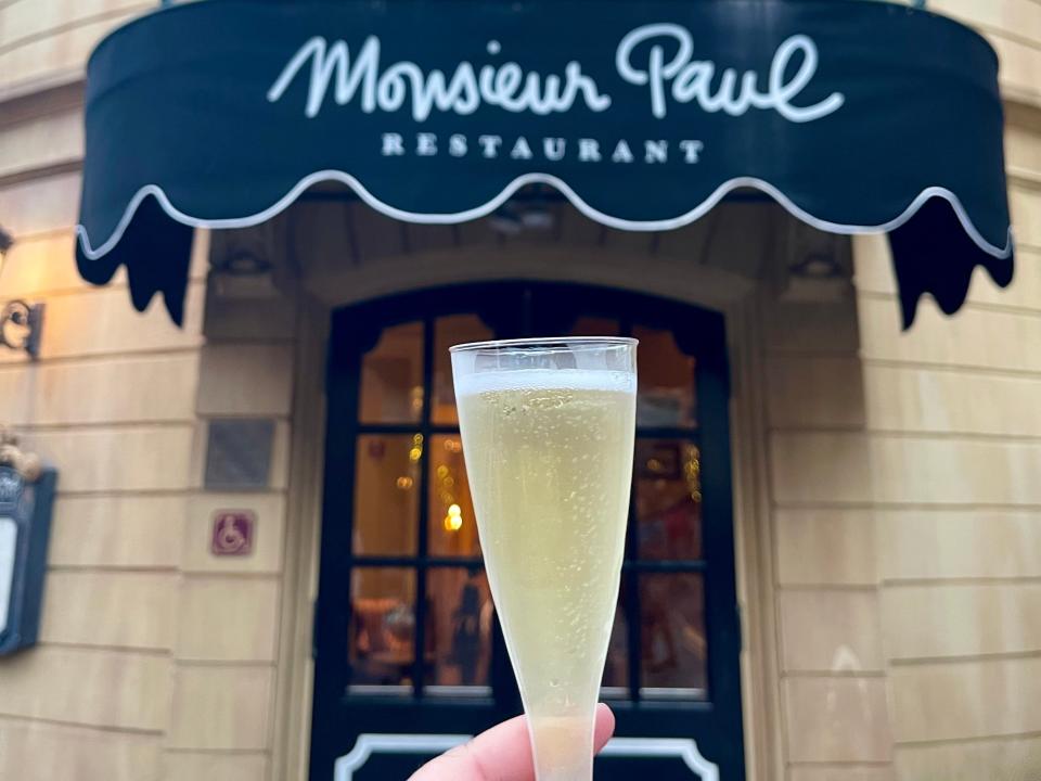 Glass of champagne in front of Monsieur Paul.