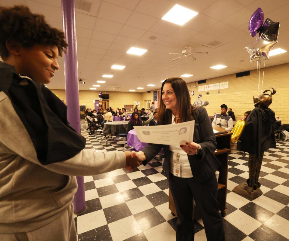 North Middle School 500 Club's Jayden Evora receives his certificate from Principal Alison Ramsay during a celebration on Tuesday, April 2, 2024 for the Brockton middle school's seventh and eighth grade students who achieved a score of 500 or more on their MCAS math and English tests on Tuesday, April 2, 2024.