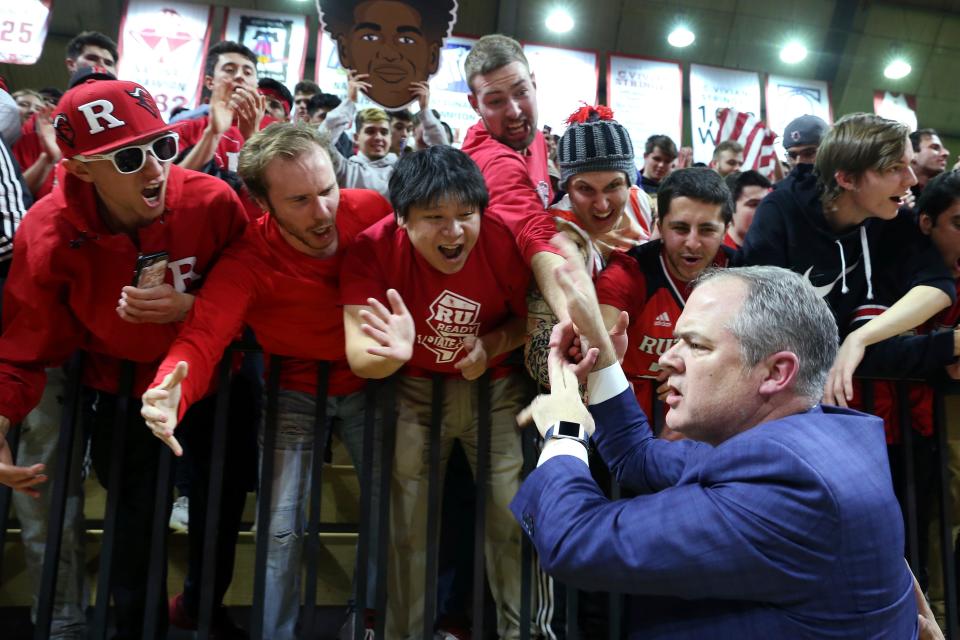 Rutgers head coach Steve Pikiell celebrates with fans after a win over Penn State in 2020
