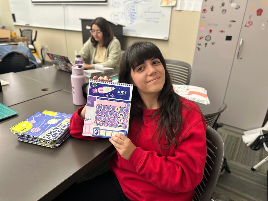 Junior Alyssa Garcia shows off her eclipse inspired cosmic calendar. (Courtesy: Eric Henrikson/KXAN)