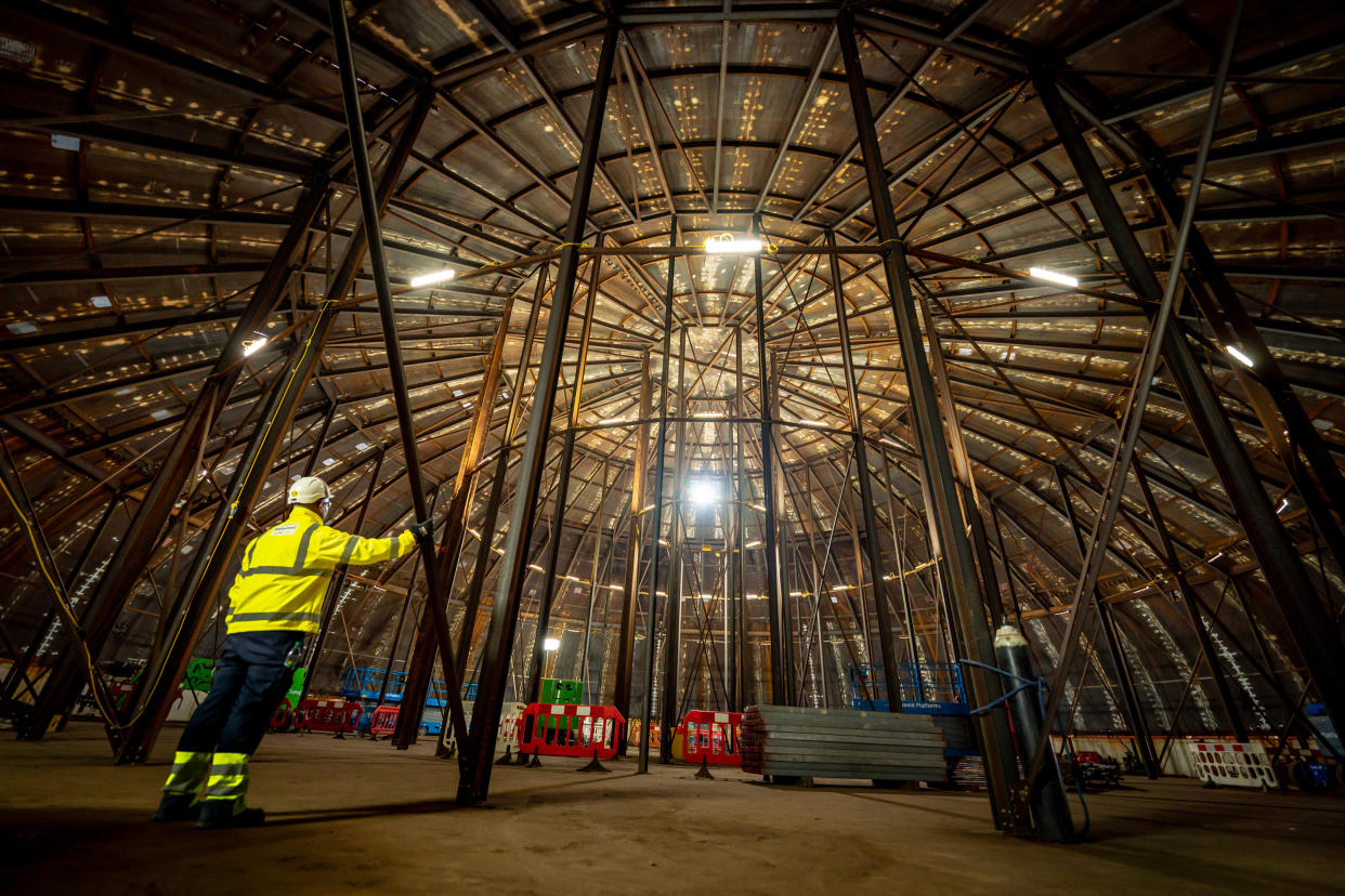 UK energy strategy EMBARGOED TO 0001 WEDNESDAY SEPTEMBR 29 A construction worker stands inside a welded steel dome that will be lifted and placed on top of the nuclear island, which houses the reactor, at Hinkley Point C nuclear power plant near Bridgwater in Somerset, as work on the project reaches the five year anniversary. Five years after getting the go-ahead, the number of people across Britain working on the Hinkley Point C power station has reached 22,000. The growing number includes 6,300 on site, compared to just 1,500 at the height of the pandemic last year. Picture date: Thursday September 23, 2021.