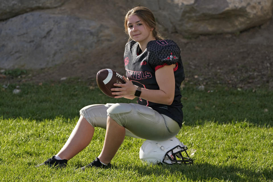 Sam Gordon poses for a photograph, Oct. 20, 2020, in Herriman, Utah. Gordon was the only girl in a tackle football league when she started playing the game at age 9. Now, Gordon hopes she can give girls a chance to play on female-only high school teams through a lawsuit. (AP Photo/Rick Bowmer)