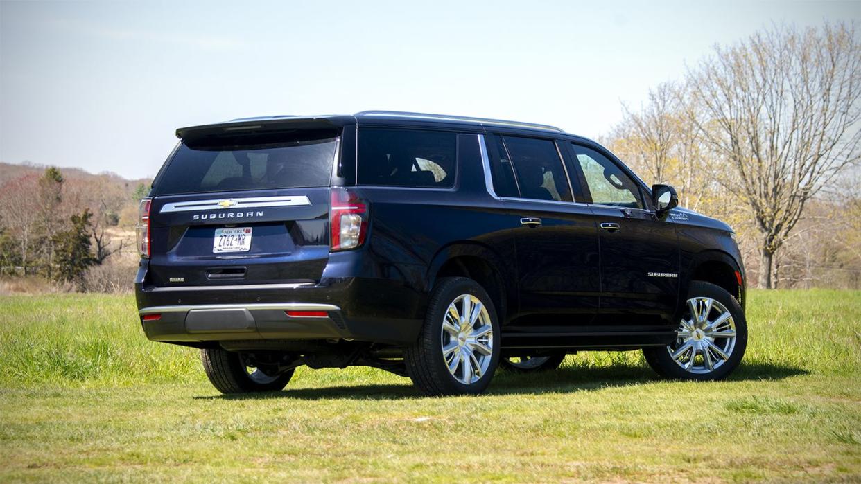 a black suv parked in a field